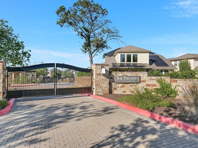 view of gate featuring solar panels