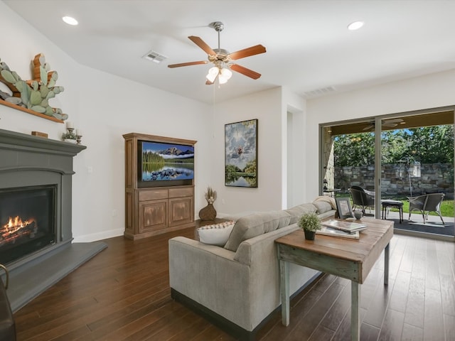 living room with ceiling fan and dark hardwood / wood-style flooring