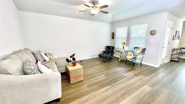 living room featuring hardwood / wood-style floors, vaulted ceiling, and ceiling fan