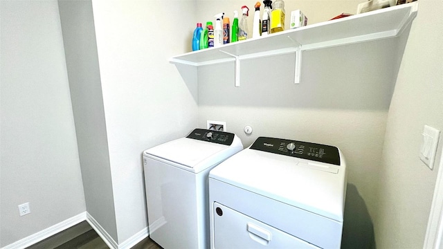 washroom with dark hardwood / wood-style flooring and washer and clothes dryer