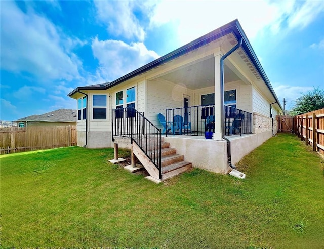 back of house featuring a yard