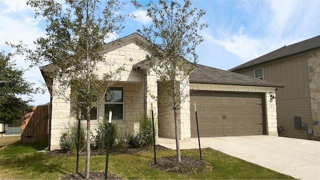 view of front of home with a front yard and a garage