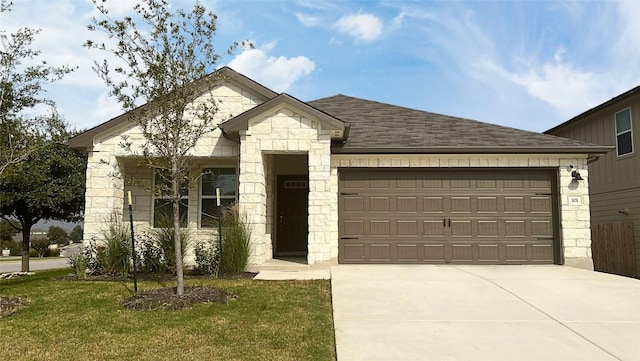 view of front of home with a garage and a front yard