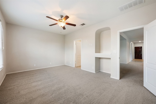 unfurnished room with ceiling fan and light carpet