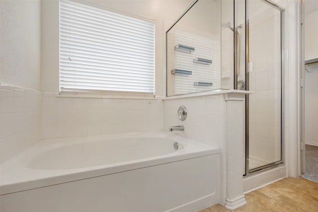 bathroom with separate shower and tub