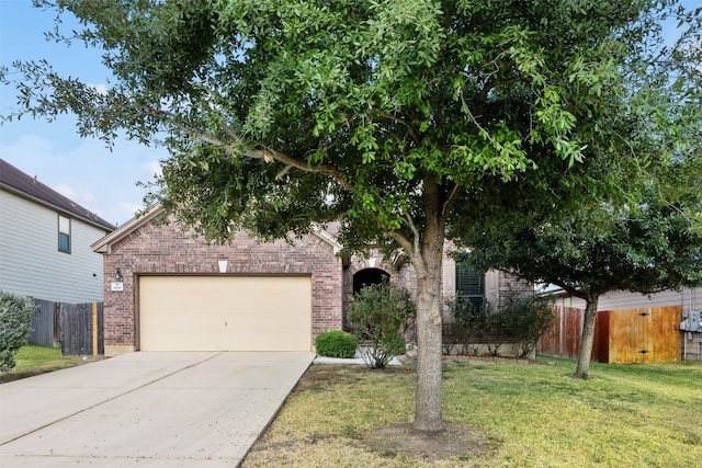 obstructed view of property with a front lawn and a garage