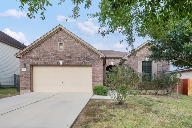 view of front of property featuring a garage and a front yard