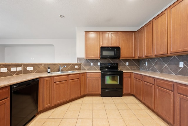 kitchen with black appliances, backsplash, sink, and light tile patterned floors