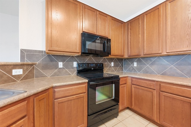 kitchen with black appliances, decorative backsplash, and light tile patterned flooring