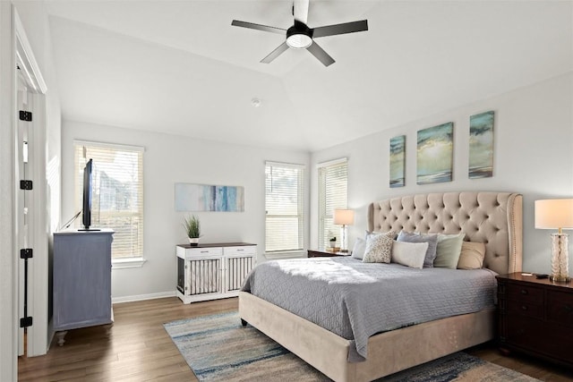 bedroom with multiple windows, ceiling fan, dark hardwood / wood-style flooring, and lofted ceiling