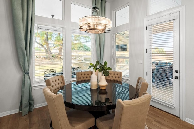 dining room featuring hardwood / wood-style floors and an inviting chandelier