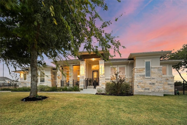 prairie-style home featuring a lawn