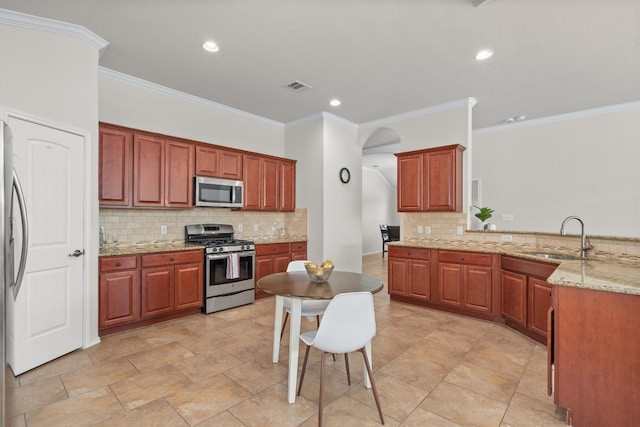 kitchen with crown molding, stainless steel appliances, backsplash, and sink