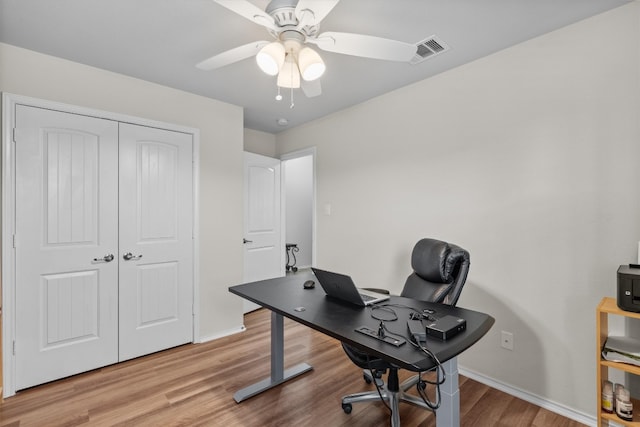 office area with ceiling fan and light hardwood / wood-style flooring