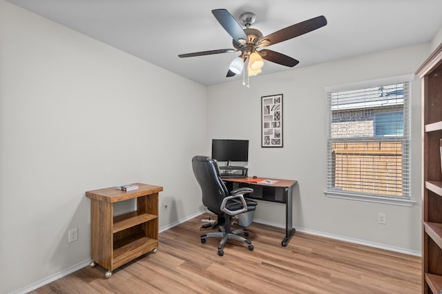 home office with ceiling fan and light hardwood / wood-style flooring