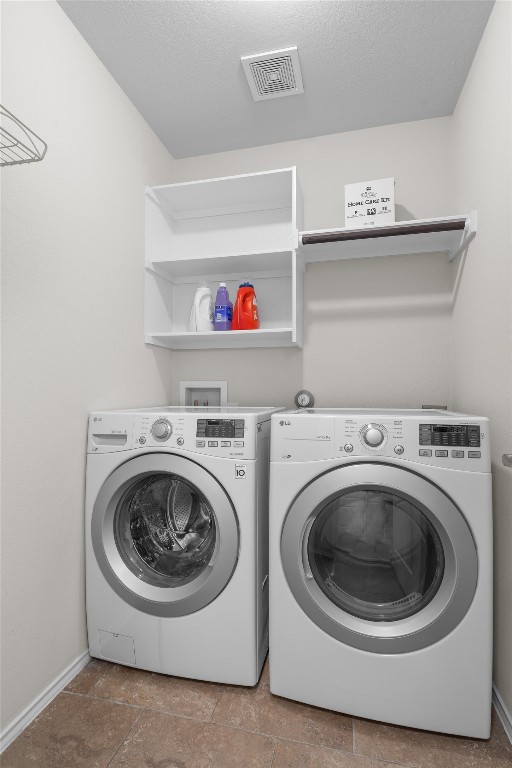 clothes washing area with separate washer and dryer