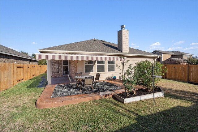 rear view of property with a patio area and a lawn