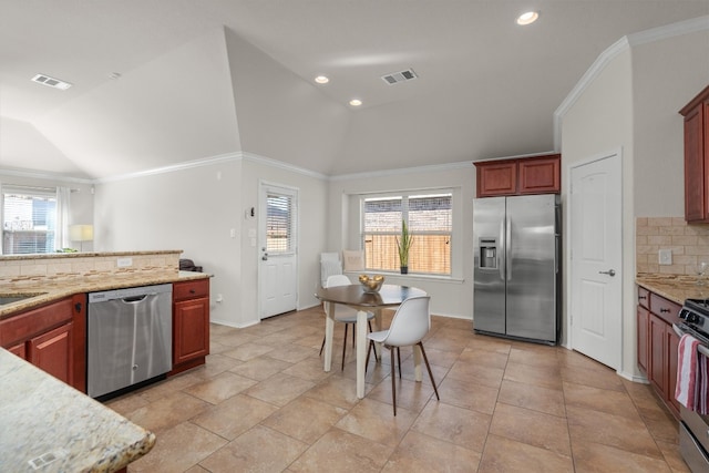 kitchen featuring stainless steel appliances, tasteful backsplash, vaulted ceiling, and a healthy amount of sunlight