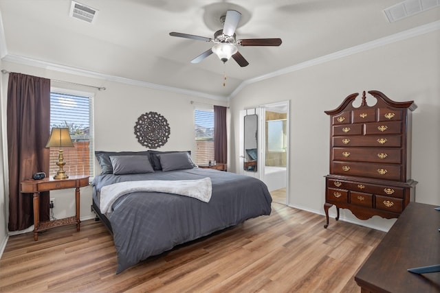 bedroom with lofted ceiling, ensuite bath, ceiling fan, and multiple windows