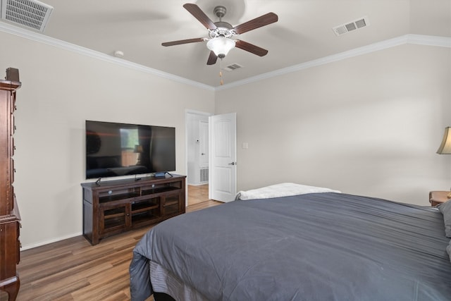 bedroom with ceiling fan, hardwood / wood-style flooring, and ornamental molding