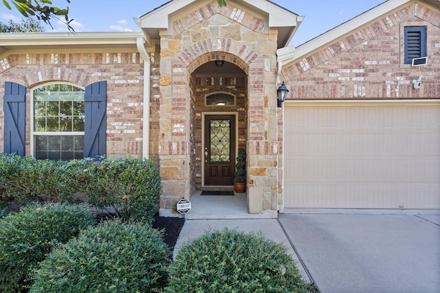 view of exterior entry with a garage