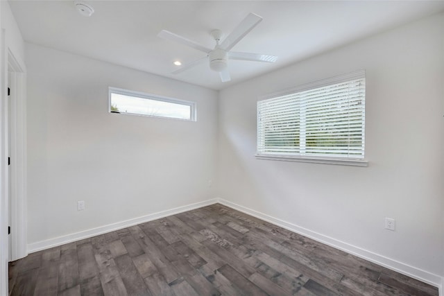 spare room with dark wood-type flooring and ceiling fan