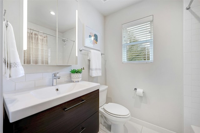 bathroom featuring toilet, vanity, tile patterned flooring, and walk in shower