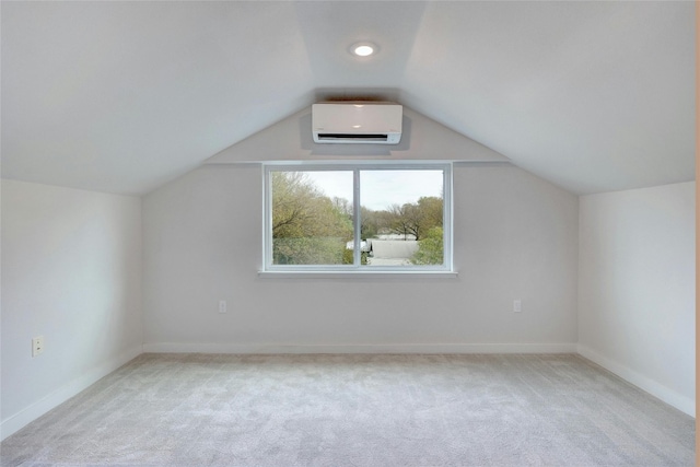 additional living space with vaulted ceiling, light carpet, and a wall mounted AC