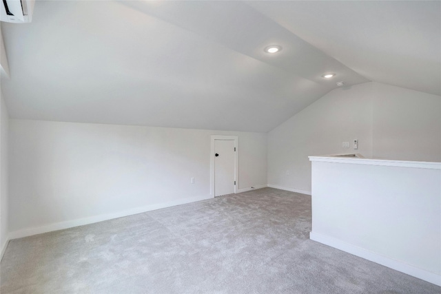 bonus room with lofted ceiling, carpet, and a wall mounted AC