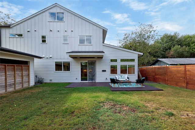 rear view of property featuring a patio area and a yard