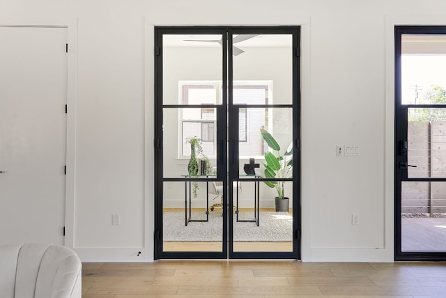 doorway to outside with light hardwood / wood-style floors and french doors