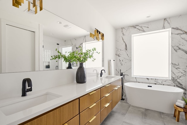 bathroom with tile walls, independent shower and bath, and vanity