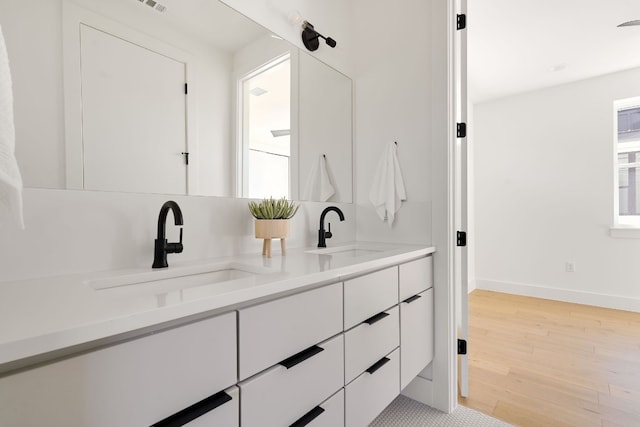 bathroom with wood-type flooring and vanity