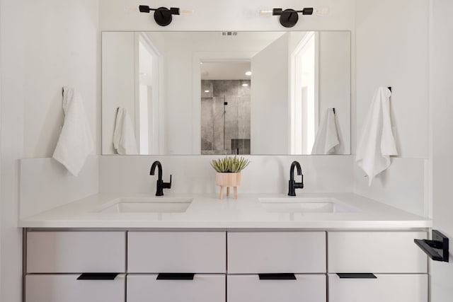 bathroom featuring vanity and a shower with door