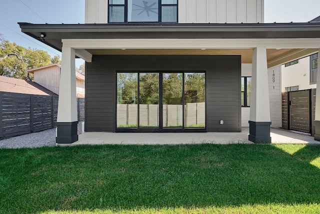 rear view of property with a lawn