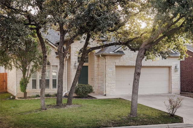 view of front of home with a front lawn and a garage