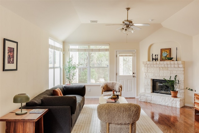 living room with ceiling fan, a healthy amount of sunlight, light wood-type flooring, and lofted ceiling