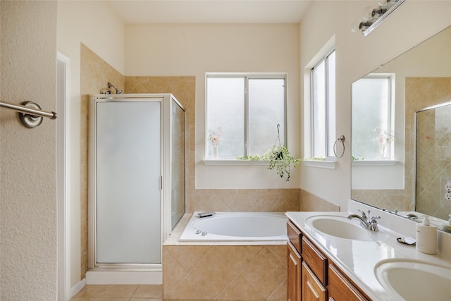 bathroom with vanity, tile patterned floors, and plus walk in shower