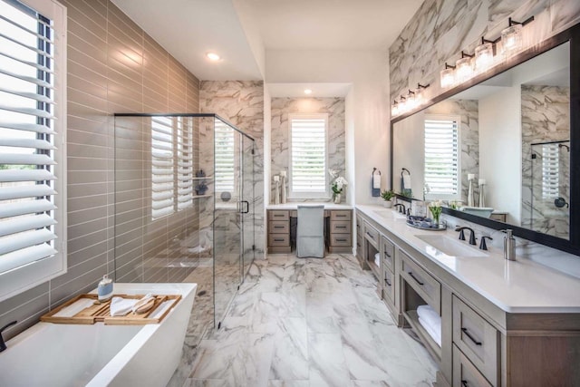 bathroom with vanity, independent shower and bath, and tile walls