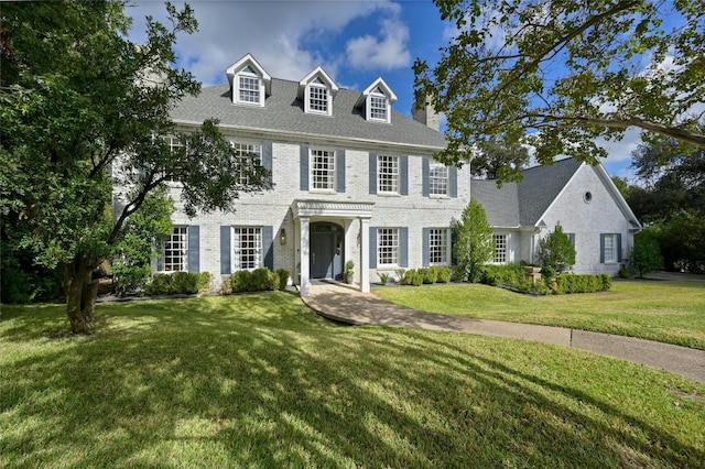 colonial-style house with a front lawn