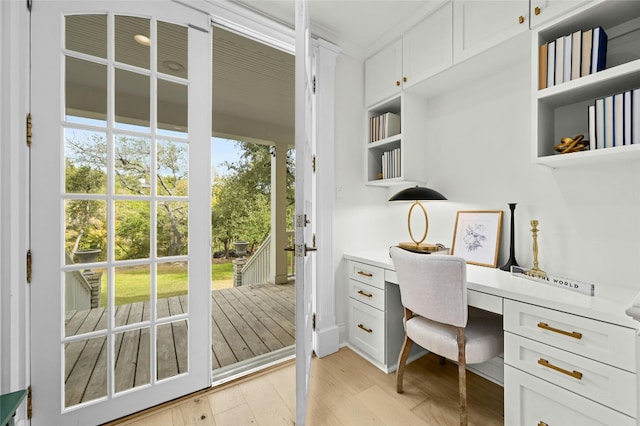 office featuring built in desk and light hardwood / wood-style flooring