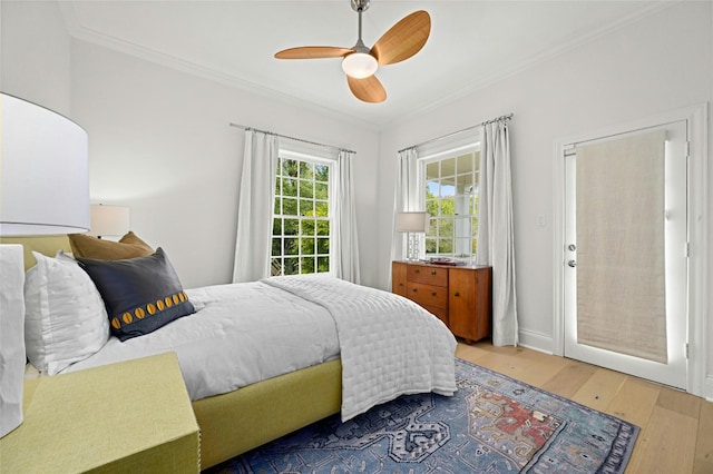 bedroom with ornamental molding, hardwood / wood-style flooring, and ceiling fan