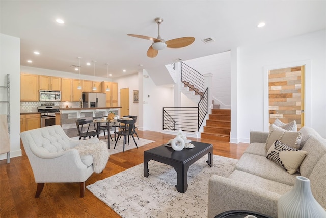 living room featuring light hardwood / wood-style floors and ceiling fan