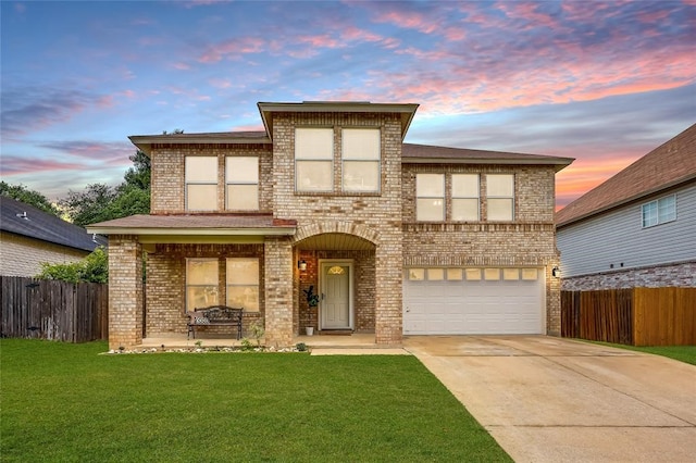 view of front of house featuring a garage and a yard