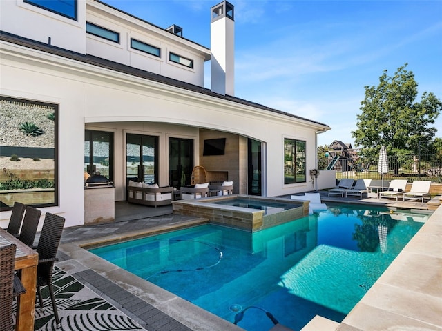 view of swimming pool featuring an in ground hot tub, outdoor lounge area, and a patio area