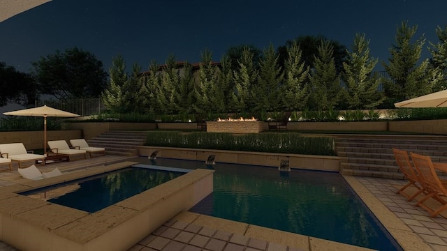 pool at twilight featuring a patio area