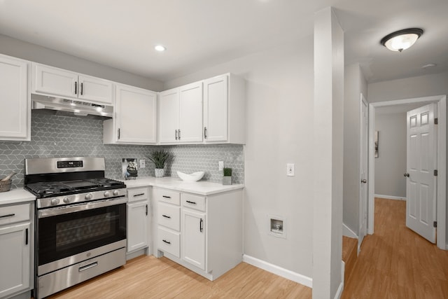 kitchen with backsplash, light hardwood / wood-style floors, white cabinetry, and gas range