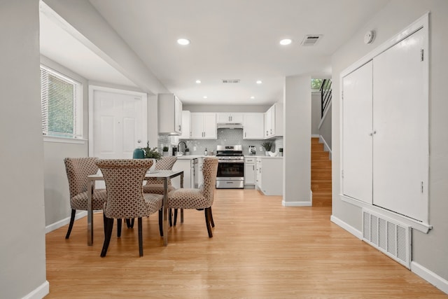 dining area featuring light hardwood / wood-style flooring and sink