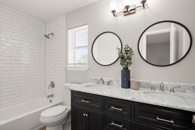 full bathroom featuring vanity, toilet, and tiled shower / bath combo