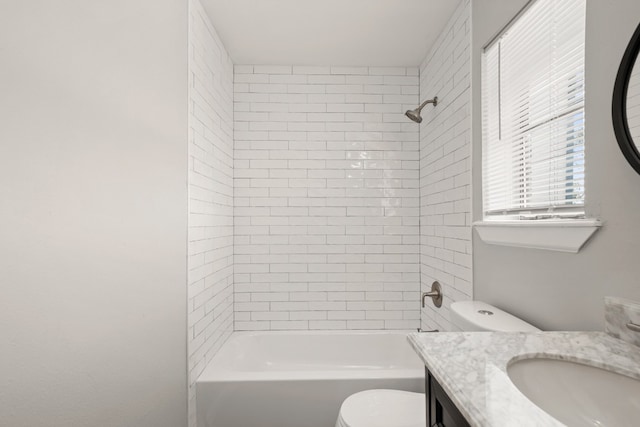 full bathroom with vanity, toilet, and tiled shower / bath